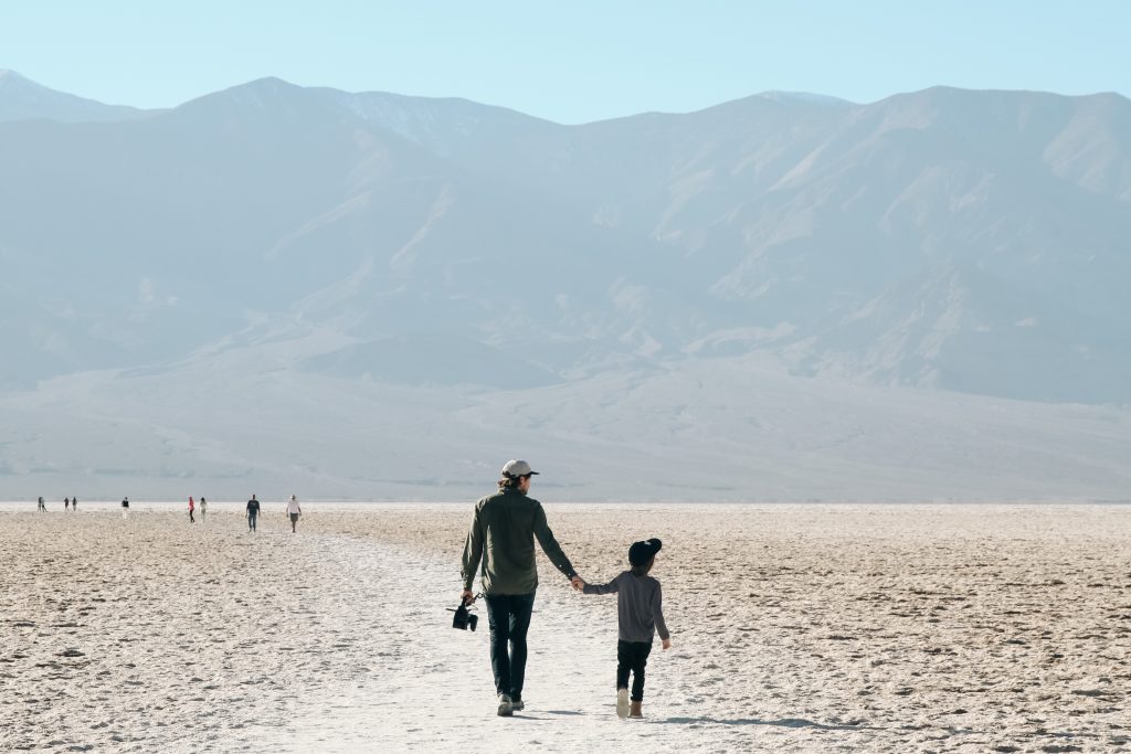 Father and son walking in Death Valley National Park on family vacation
