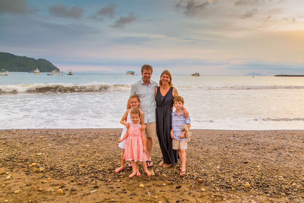 Family posing on beacj