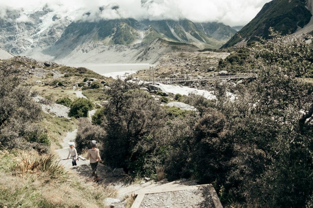 Family hiking on Hooker Valley Track in New Zealand