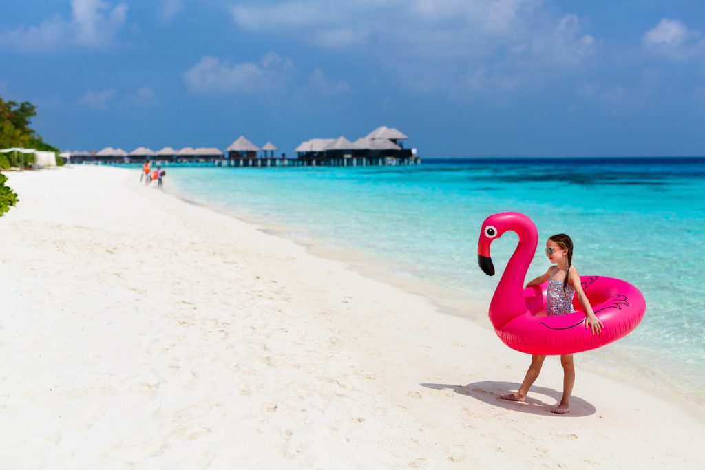 Child enjoying beautiful Maldives beach