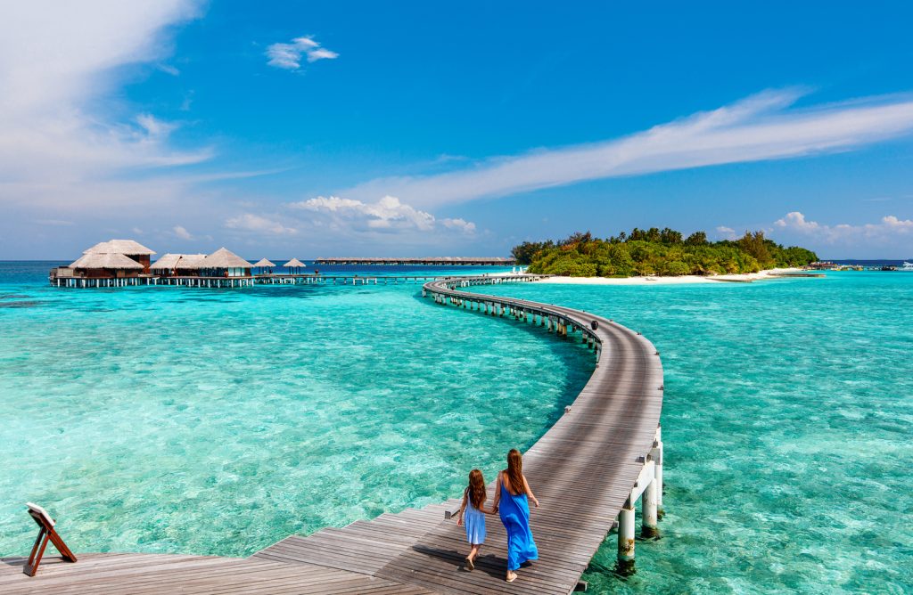 Family on boardwalk in Maldives