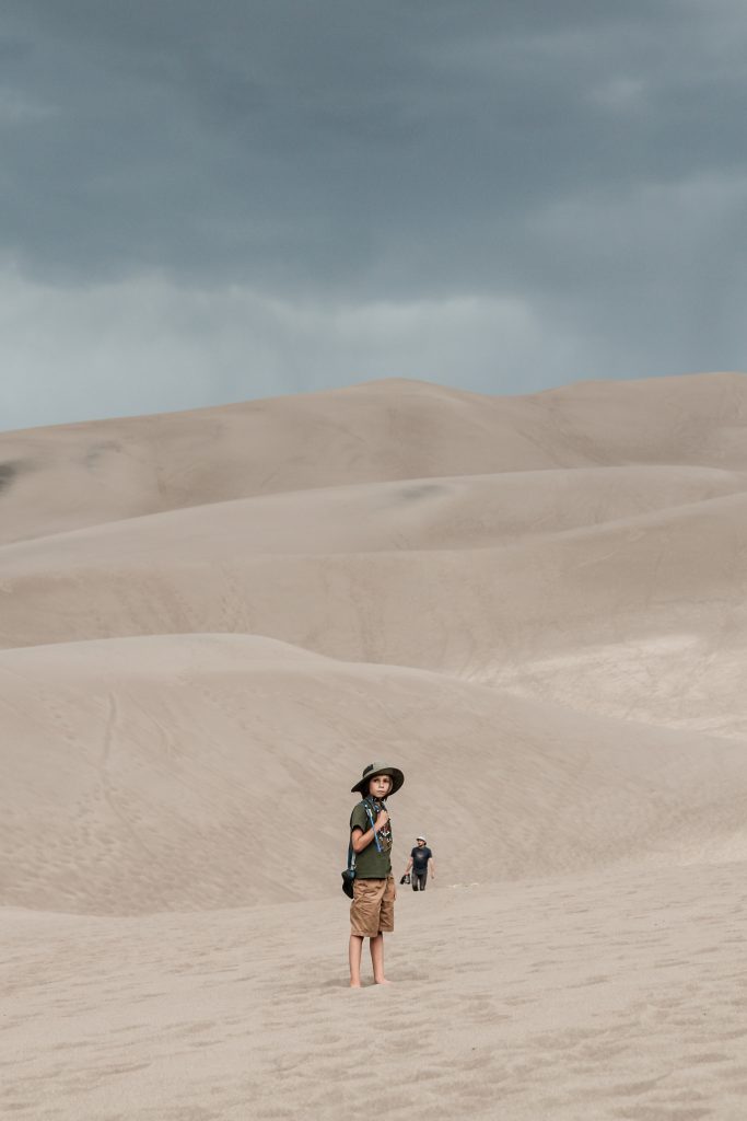 Boy hiking through Great Sand Dunes National Park