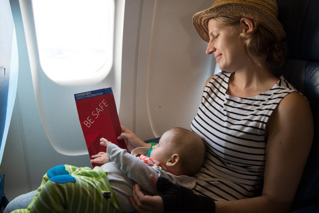 flying with kids: baby and mom on plane