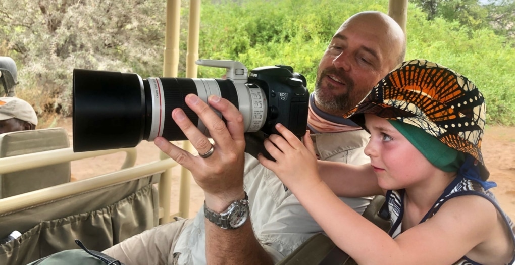 African Safari Holidays: dad teaching son how to use a camera