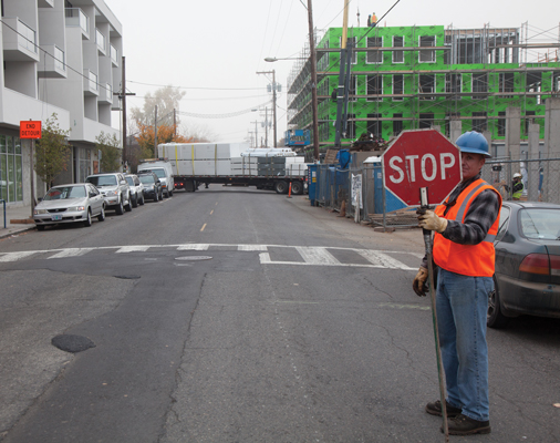 Division Street in Southeast Portland: Construction continues on several mixed-use buildings and the infrastructure that goes with them. With hundreds of new units being built and little to no additional parking, density and congestion will continue in close-in Portland. Photo by Tim LaBarge.