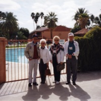 Juanita and Harry Anderson standing next to another couple in front of gated pool<br />
