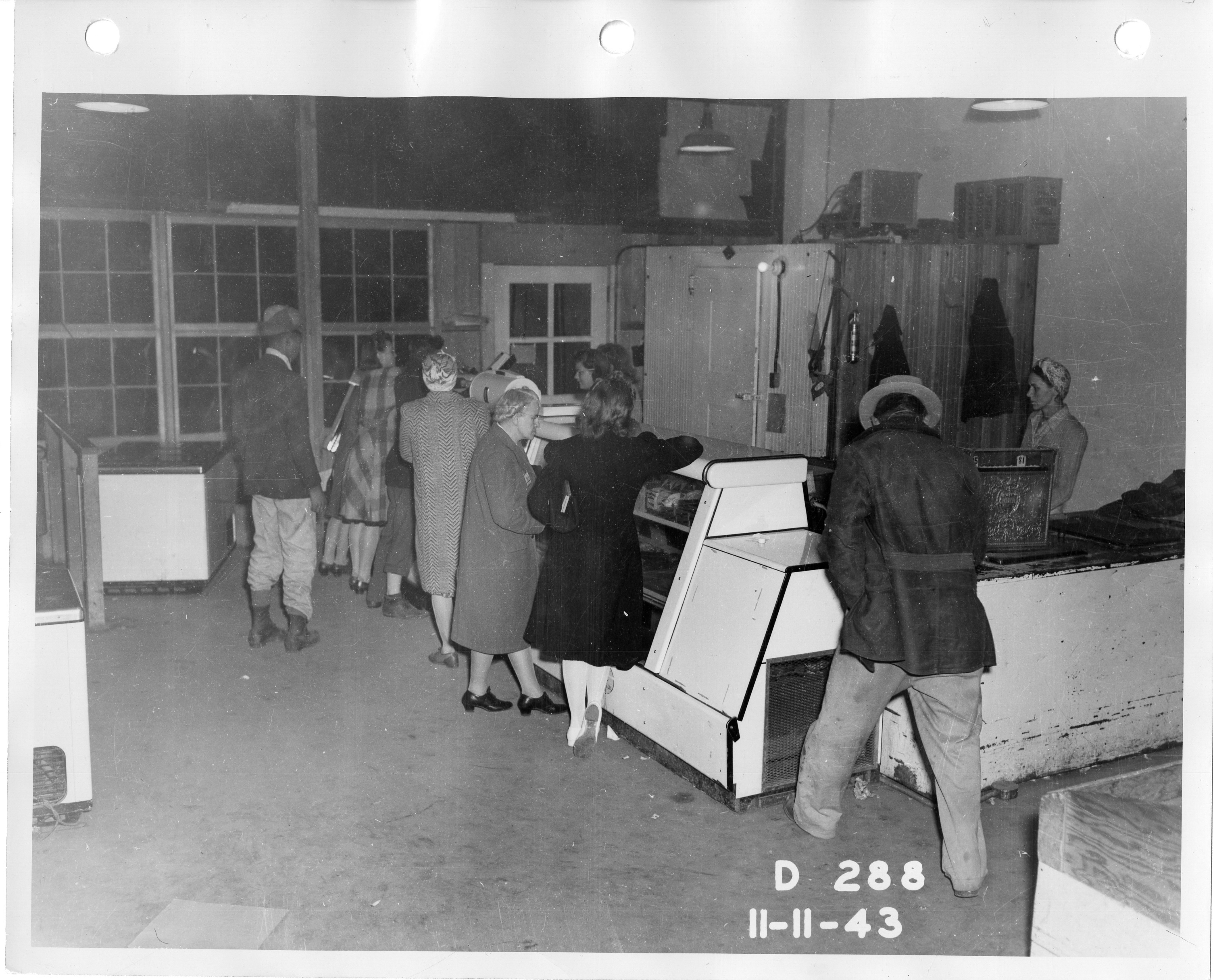 Workers in line at Hanford Construction Camp Meat Market. · Hanford