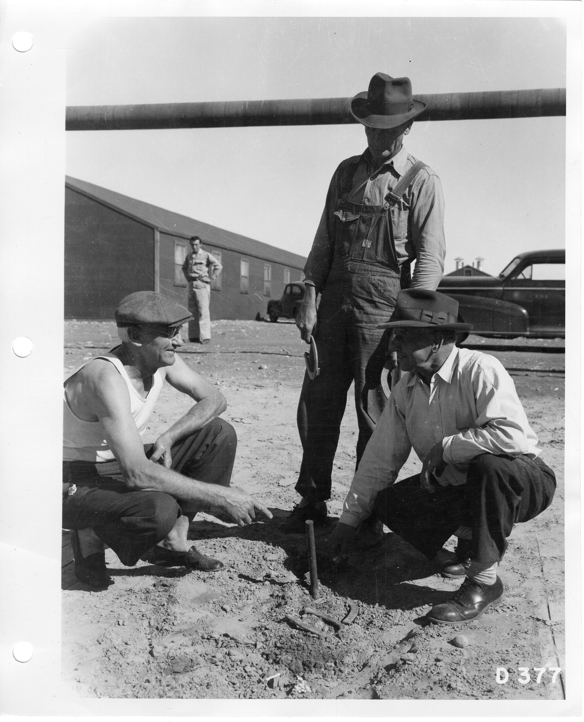 Three men playing a game of horseshoes. · Hanford History Project