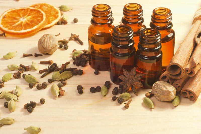 Essential-oils-in-glass-bottles-and-spices-anise-nutmeg-cardamon-cinnamon-clove-pepper.jpg