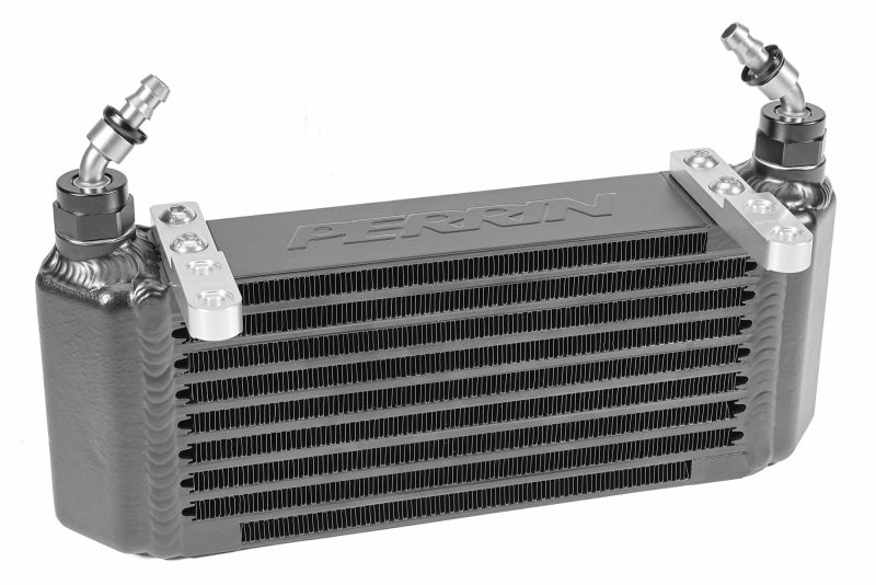 A black PERRIN Transmission Oil Cooler with fittings and mounting brackets installed.