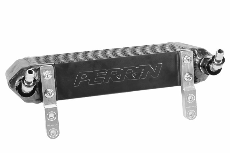 A black PERRIN Transmission Oil Cooler with fittings and mounting brackets installed.