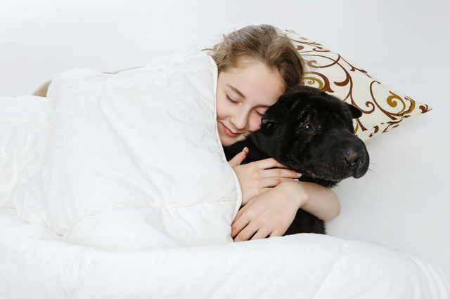 Teen girl sleeping with dog