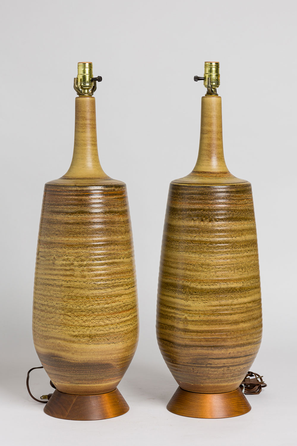 Pair of mid century american ceramic earth glaze table lamps on wood bases