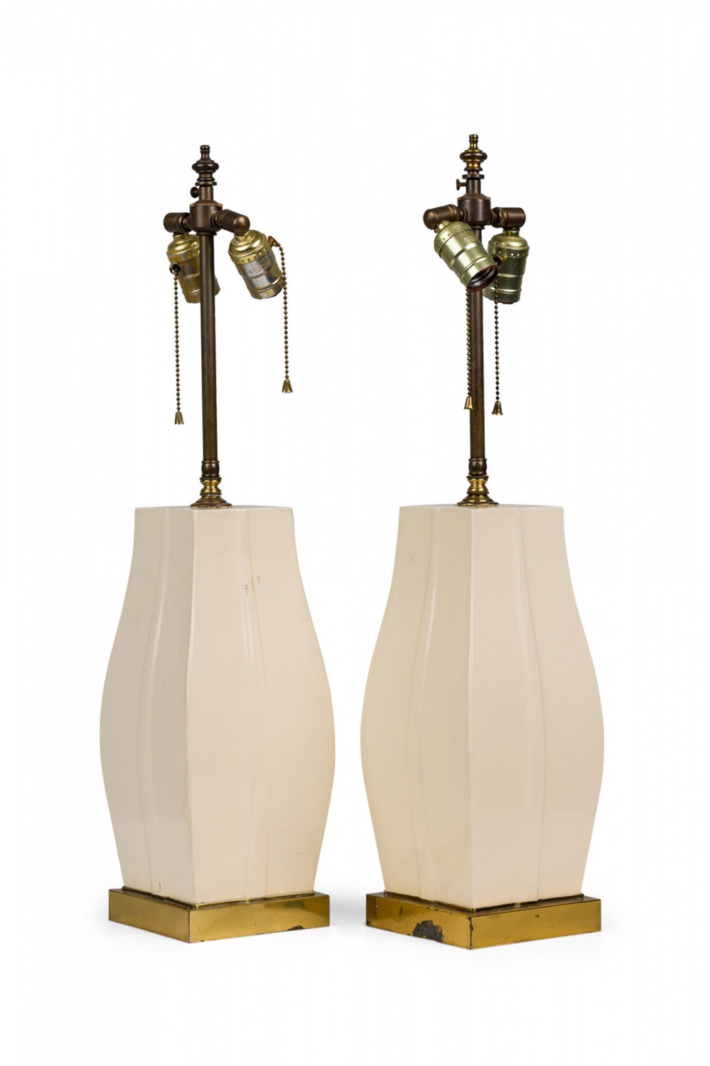 Pair of mid century american white lacquer bombe form table lamps on brass bases