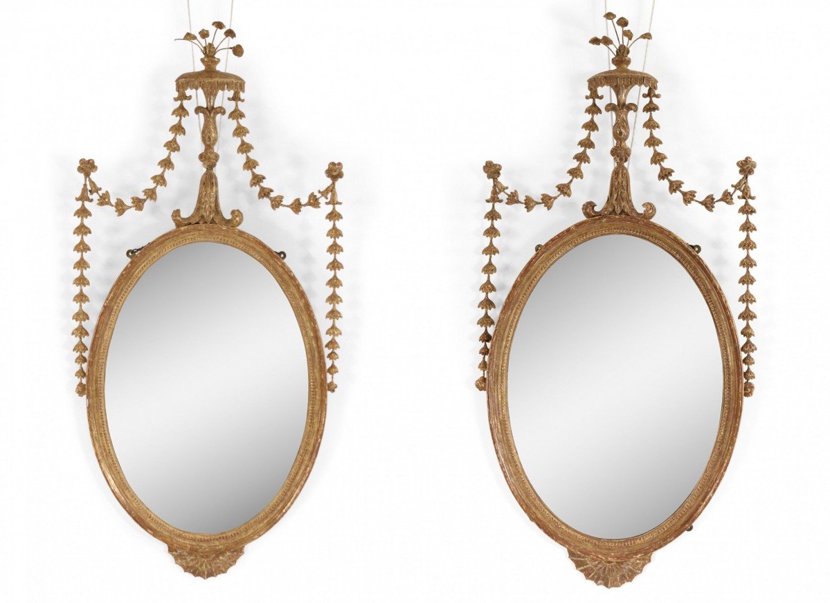 Pair of english adam style oval giltwood wall mirrors