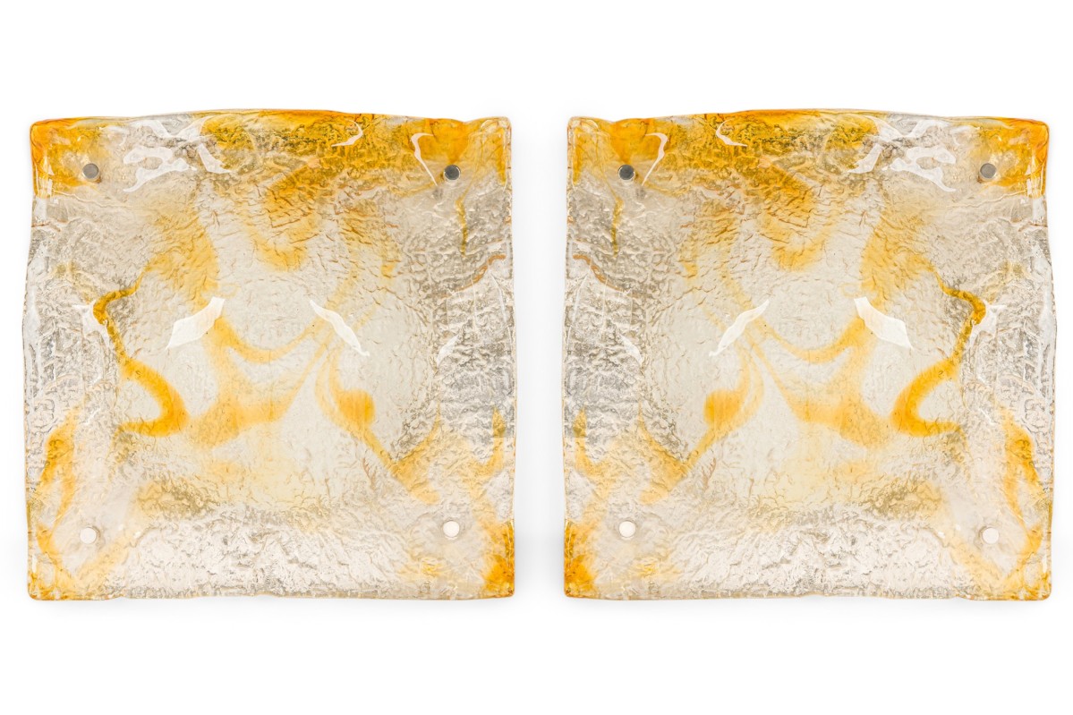 Pair Contemporary textured clear and amber glass sconces with a half round freeform design