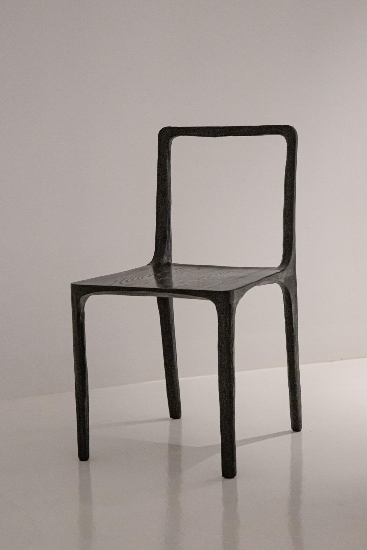 French contemporary charred oak side chairs