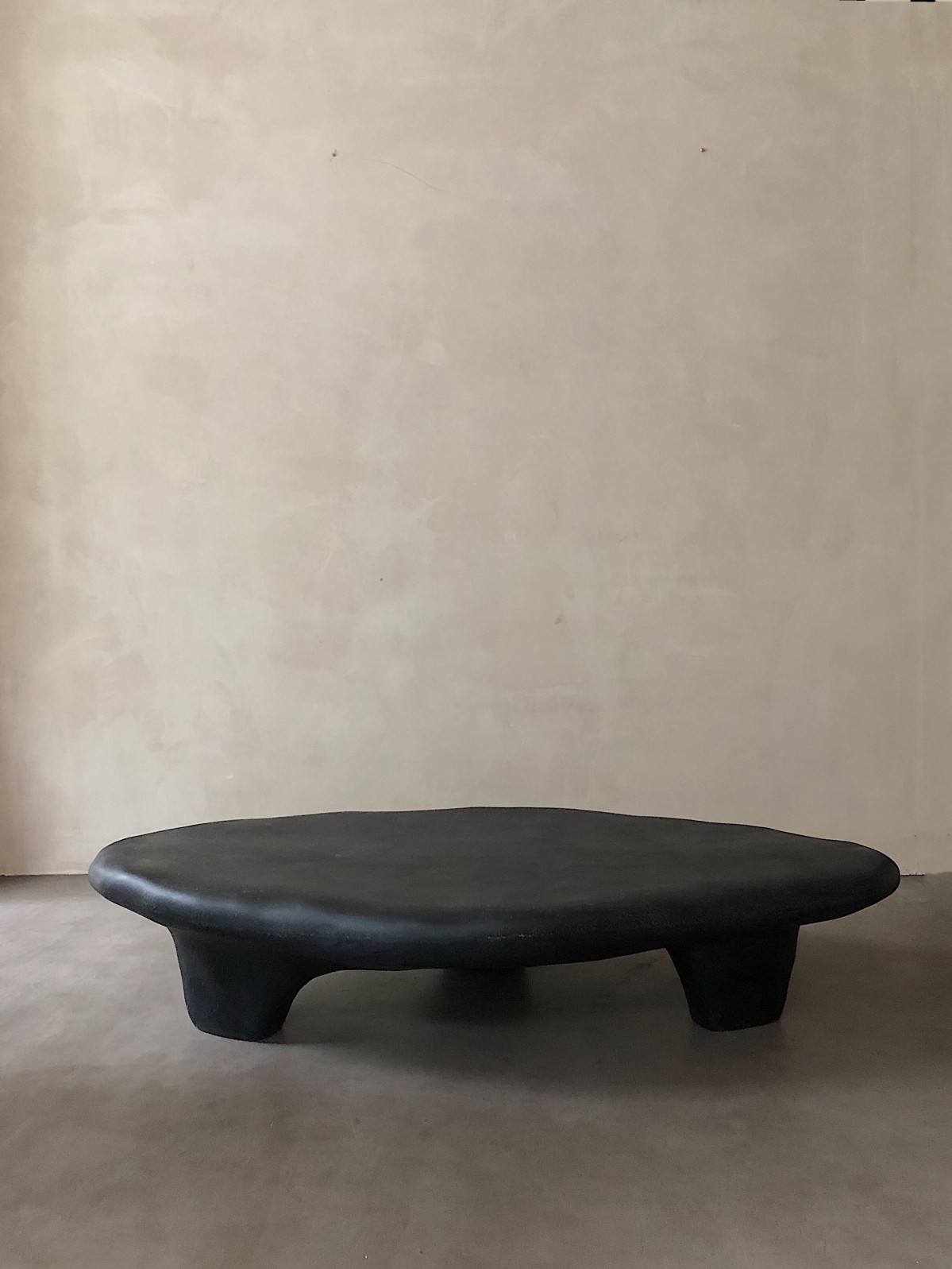 Contemporary black tripod fiberglass coffee table
