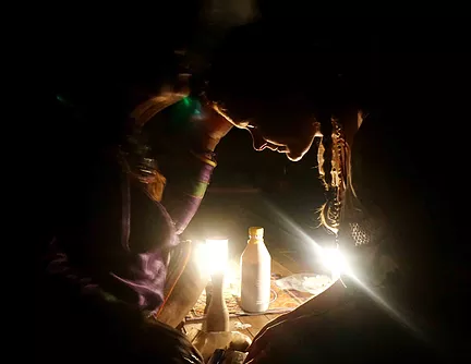 shipibo maestra curandera from the amazon jungle blows sacred tobacco over women during traditional ayahuasca ceremony in the sacred valley cusco peru, safe and reputable ayahuasca retreats with experienced facilitators and powerful integral healers.