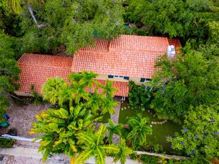 Aerial closeup of property with tropical trees and flowers