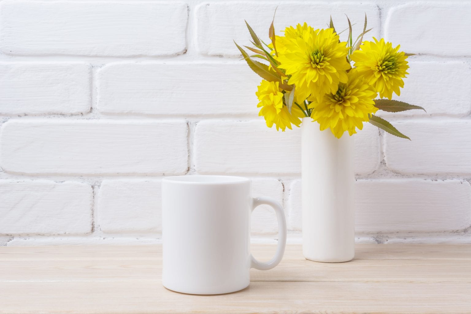 White coffee mug mockup with yellow rudbeckia Golden Ball flower. Empty mug mock up for design promotion.