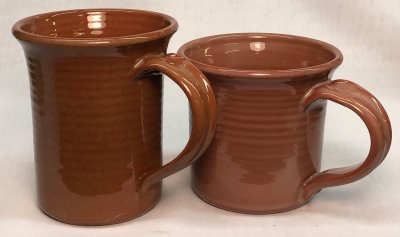 Two brilliantly transparent glazed terra cotta mugs