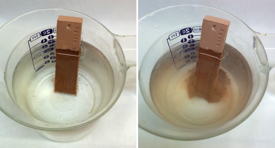 A clay bar is immersed in a cup of water and slaking.