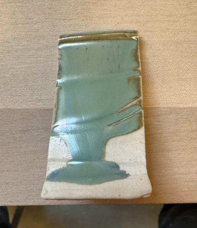 A runny reactive pottery glaze