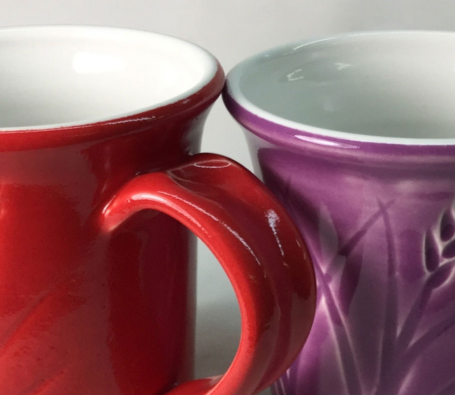 Mugs with red and purple glaze stains