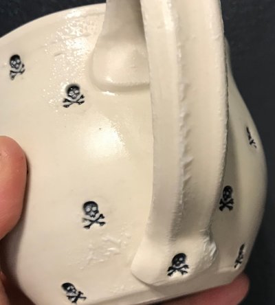 A pottery mug with wrinkled glaze on the handle