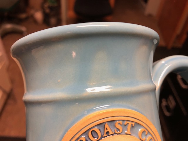 A mug with streaks of lighter blue on a darker blue background