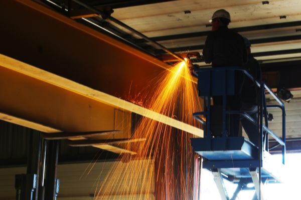 A hoist and crane technician modernizing a hoist and crane system.