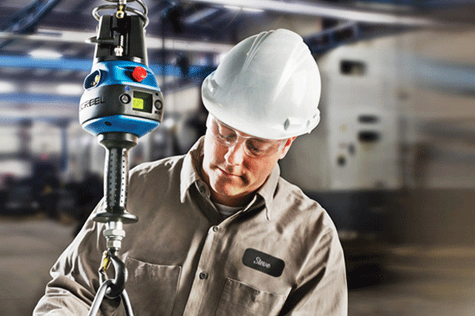 A man using a Gorbel below-the-hook (BTH) device on a hoist.