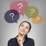Thinking business woman with many questions in bubbles above