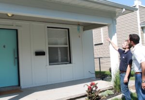 Property manager pointing at house.