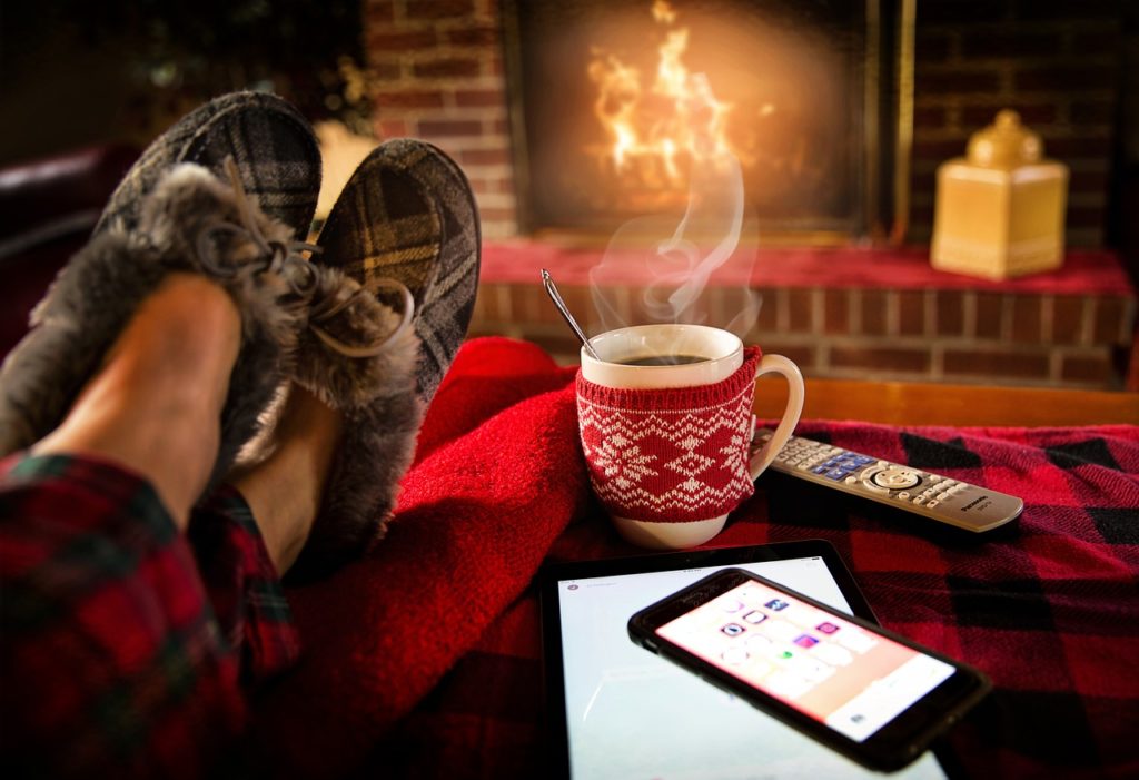 Picture of person's feet by fireplace.