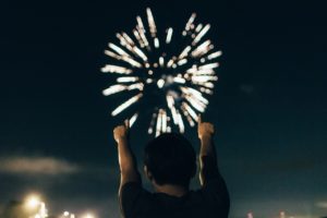 Man in front of fireworks.