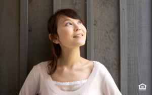 Woman standing in front of wood panel at a rental property.