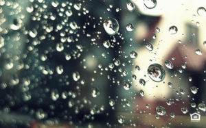 Rain drops on windw looking to house outside