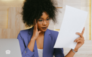 Woman holding up papers to compare landord insurance policies.