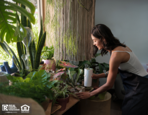 Female shop keeper tending the plants at a garden store