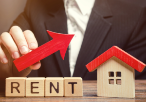Blocks Spelling Rent with an Arrow Pointing Upward