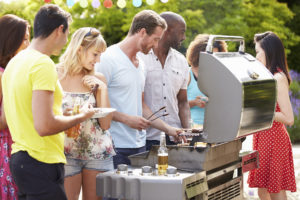 Group Of Friends Having Outdoor Barbeque At Home