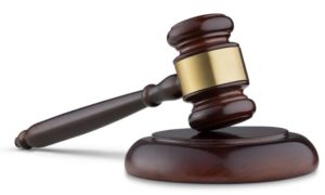 Close up of wooden gavel isolated on white background