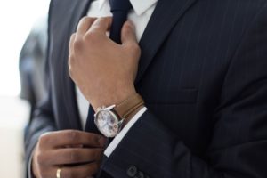 Close up of a Man Straightening His Tie