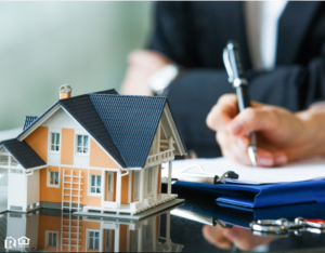 Filling Out Insurance Paperwork with a Model House in the Forefront