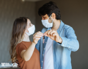 Couple with Face Masks Holding Keys to Their Norwalk Apartment