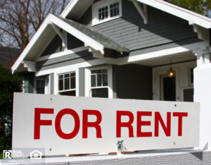 For rent sign in front of gray and white home