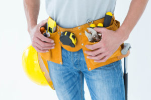 Technician with tool belt around waist