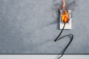 fire and smoke on electric wire plug in indoor, electric short circuit causing fire on plug socket